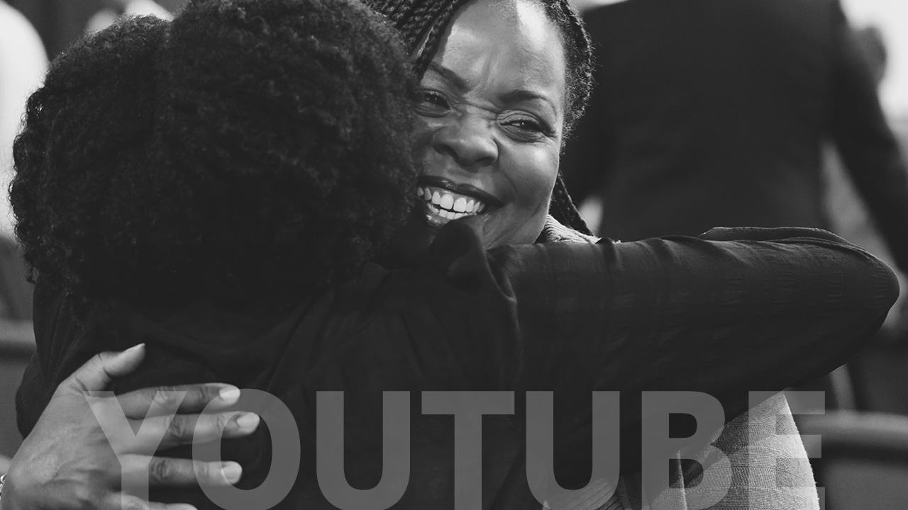 Two members embracing after a service